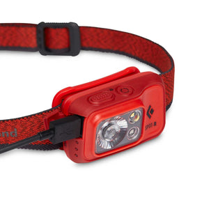 Black Diamond Spot-R headlamp with red strap and charging cable connected