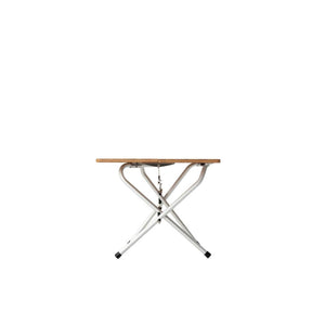 Side view of a folding table with a wooden top and white metal X frame legs