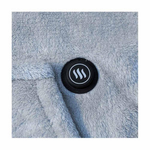 Round black power button with a heat wave icon on light blue fuzzy fabric