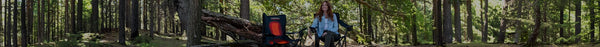 A woman with long hair smiles while sitting in a black 