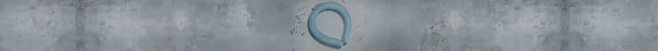 A smooth, light blue, curved tube lies on a distressed gray surface, with many small, clear fragments scattered nearby.