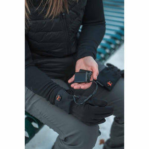 Person connecting a Mobile Warming battery pack to heated gloves