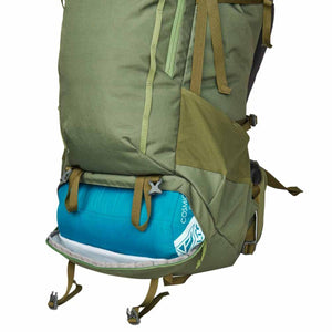 Kelty green hiking backpack with blue sleeping bag stored in the bottom compartment