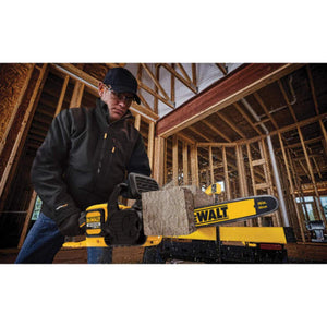 Person using a DeWalt 16 inch chainsaw to cut a wooden beam on a construction site