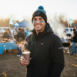 Man wearing ActionHeat jacket and Carolina Panthers beanie holding a steaming cup at a tailgate