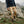 Person wearing Fjallraven beige cargo trousers and hiking boots on a rocky mountain trail