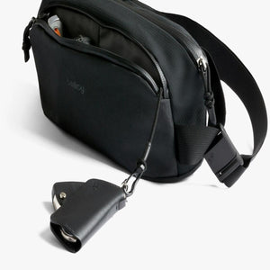 Bellroy black sling bag with key fob attached to internal strap