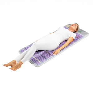 Woman lying on a HealthyLine amethyst gemstone mat