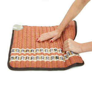 Hands pressing on a HealthyLine gemstone heating mat
