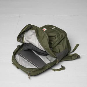 Open olive green Fjallraven backpack with laptop and clothing inside