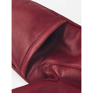 Close up of red Hestra leather mitten detail
