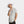 Man wearing a white bucket hat and a light grey short sleeve button down shirt