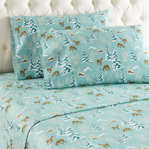 Shavel bed sheets with teal background featuring winter forest deer and cabin print