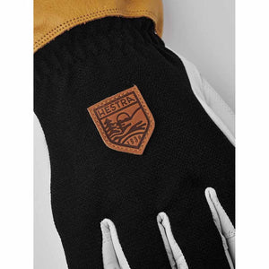 Close up of Hestra glove with leather cuff and branded patch