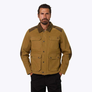 Man wearing a tan Mobile Warming canvas field jacket with dark brown collar and elbow patches