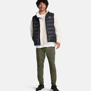 Man wearing Under Armour black puffer vest over cream zip jacket and olive green joggers