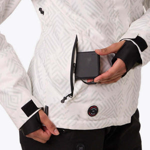 Person placing a black power bank into the zippered pocket of a white patterned heated ski jacket