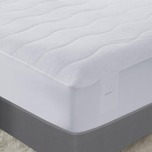 White quilted mattress protector on a bed
