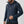 Man wearing a navy blue Fjallraven zip up fleece hoodie with drawstring hood