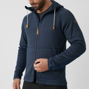 Man wearing a navy blue Fjallraven zip up fleece hoodie with drawstring hood