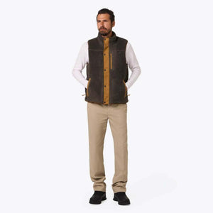 Man wearing a Mobile Warming grey fleece vest with tan trim over a white long sleeve shirt and khaki pants