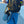 Grey slip on shoes clipped to a black backpack with a carabiner