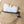 White rectangular ice pack with fill water to this line text inserted into a tan fabric pocket