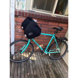 Bar Mitts handlebar covers installed on a turquoise bicycle
