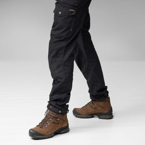 Person wearing black FjallRaven trousers and brown hiking boots