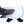 Foot in a grey sock resting inside a blue and white perforated orthopedic splint with black straps