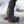 Black Muck tall rubber boots with pink logo and sole detail standing in snow