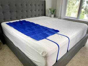 Mattress Cooler blue cooling pad secured on top of a white mattress