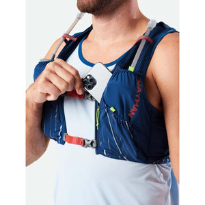 Person wearing a blue Nathan hydration vest with a smartphone in the front pocket