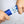 Hands using a Polar Products blue and white hand grip strengthener