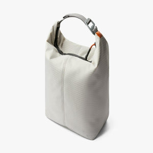 Light grey roll top dry bag with grid pattern and top handle