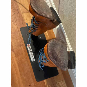 Two brown leather boots placed on a black Cyclone Dryers boot drying stand