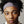 Close up portrait of a person with curly hair wearing a grey headband