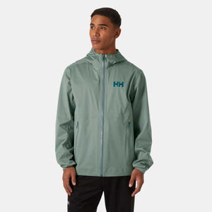 Man wearing a sage green Helly Hansen hooded rain jacket with HH logo
