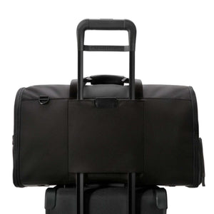 Black Briggs and Riley travel bag attached to a luggage handle