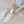 Person inserting white electric shoe dryer into white sneaker