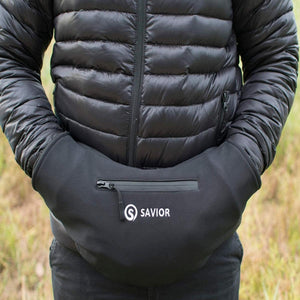 Person wearing a black Savior branded hand warmer muff over a black puffer jacket
