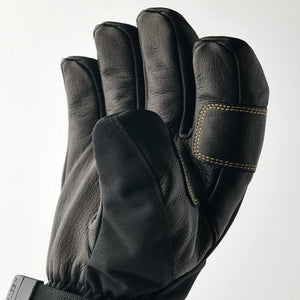 Hestra black leather ski glove with yellow stitching detail