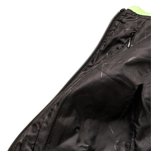 Close up of black jacket lining with zipper and neon green collar detail