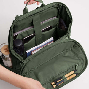 Open olive green Got Bag backpack showing internal laptop sleeve, pockets, and pen holders