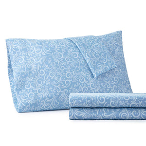 Blue pillowcase and folded sheets with white floral damask pattern