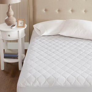 Beautyrest white quilted mattress pad on a bed