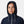 Woman wearing a navy blue hooded rain jacket with white drawstring cords