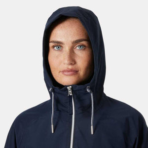 Woman wearing a navy blue hooded rain jacket with white drawstring cords
