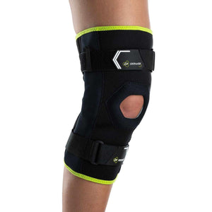 DonJoy black knee brace with neon green trim and adjustable straps worn on a leg
