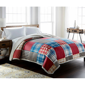 Shavel plaid patchwork comforter with sherpa lining on a bed